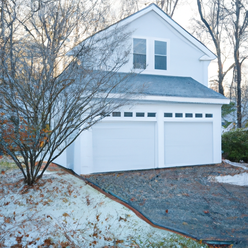 Colonial home in Burlington, MA with a white insulated sectional garage door and light frost on the driveway at morning light.