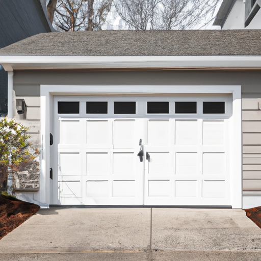 White carriage-style garage door on a suburban Burlington, MA home in early spring, no people.